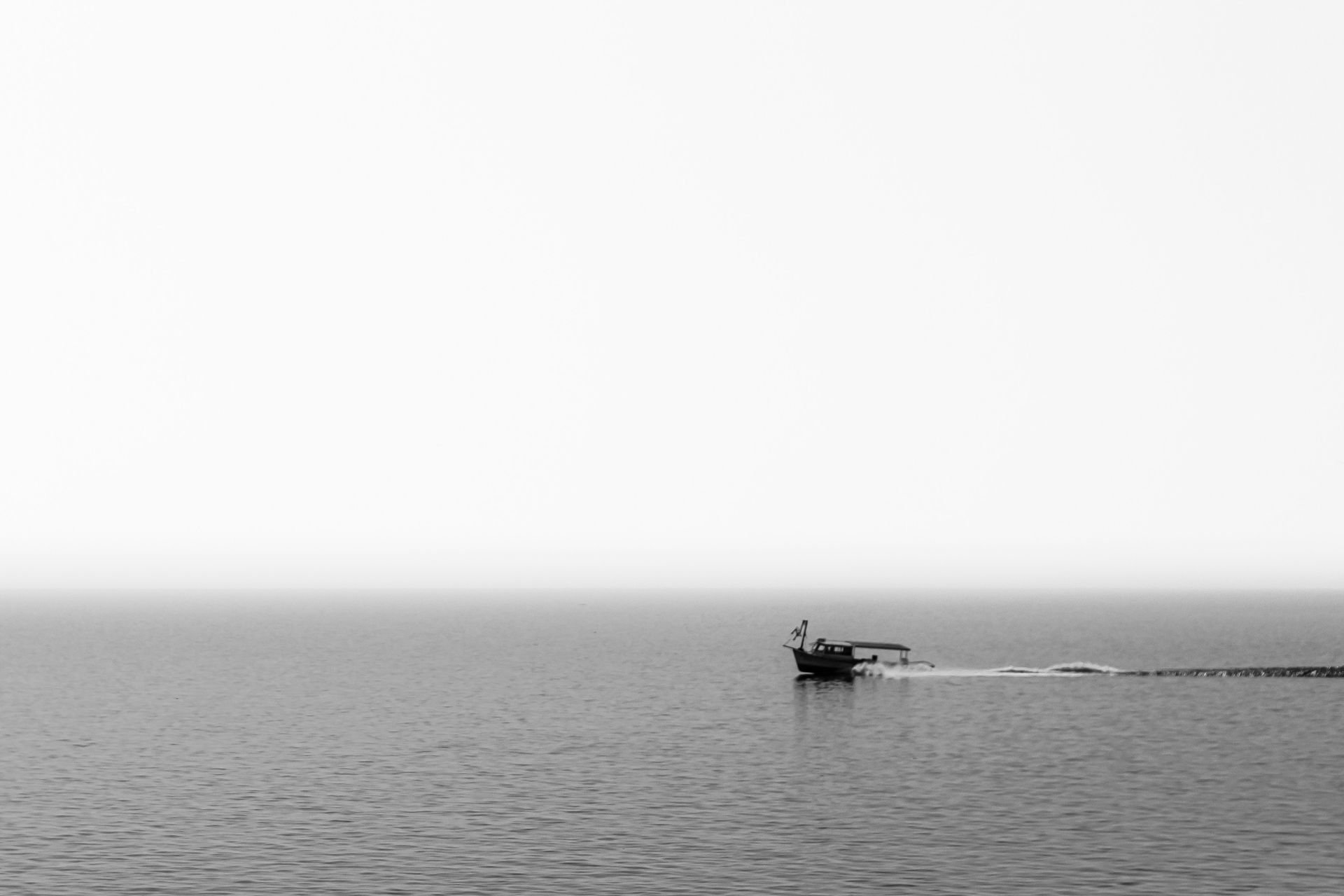 Boat on the grey waters of Lake Pontchartrain near New Orleans, Louisiana