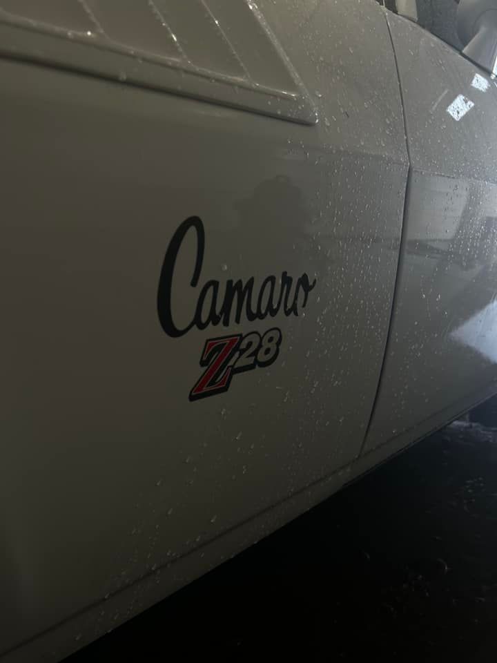Close-up of a gray Chevrolet Camaro Z/28 badge on the car’s side panel