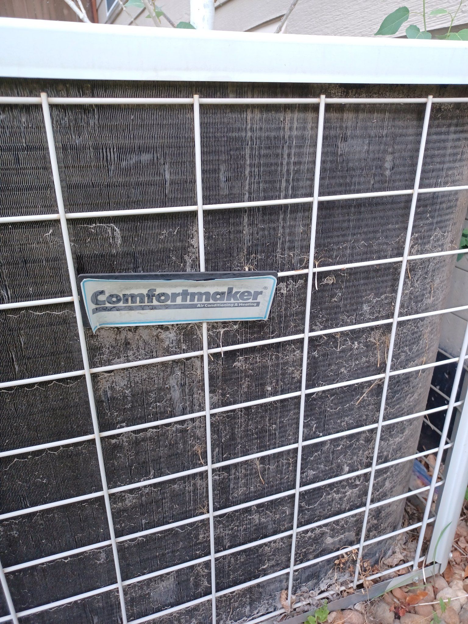 A Comfortmaker air conditioning unit with a metal grid cover.