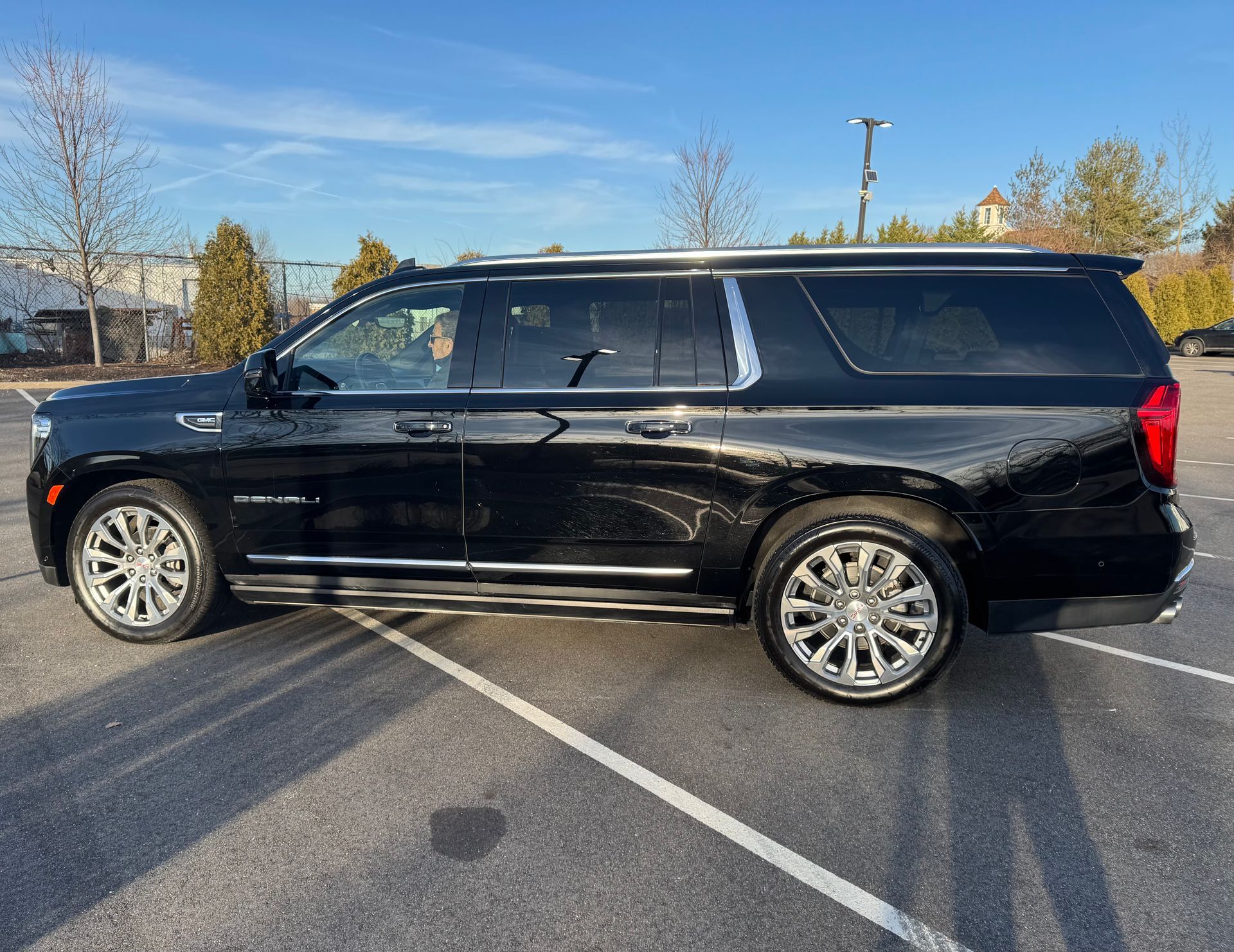 A black suv is parked in a parking lot.