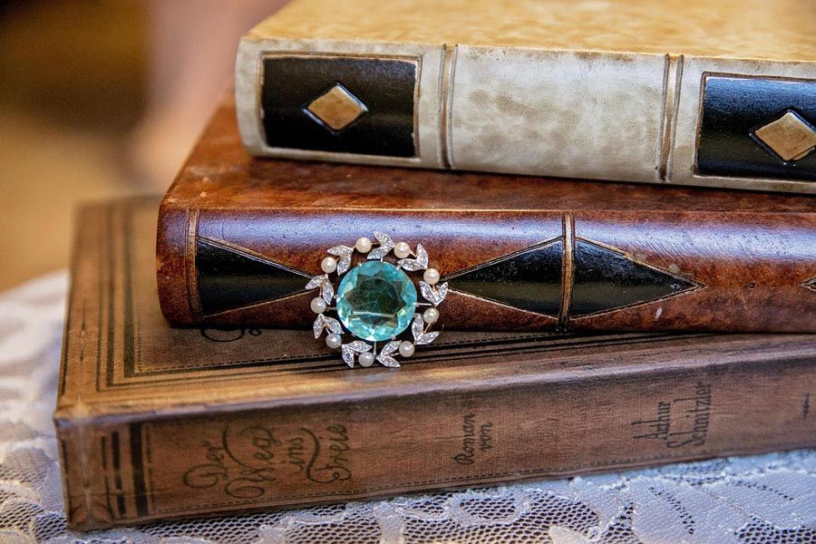 Decorative vintage books with a jeweled ring resting on top