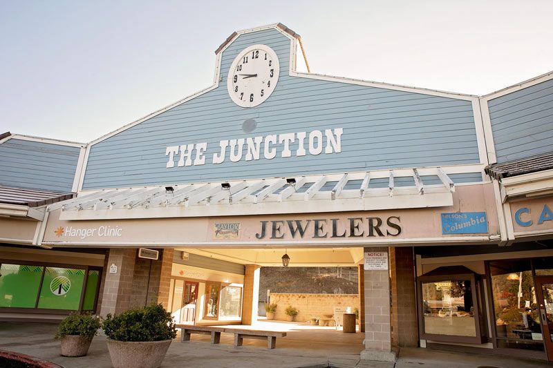 The Junction shopping center storefront with a clock tower and jewelry sign