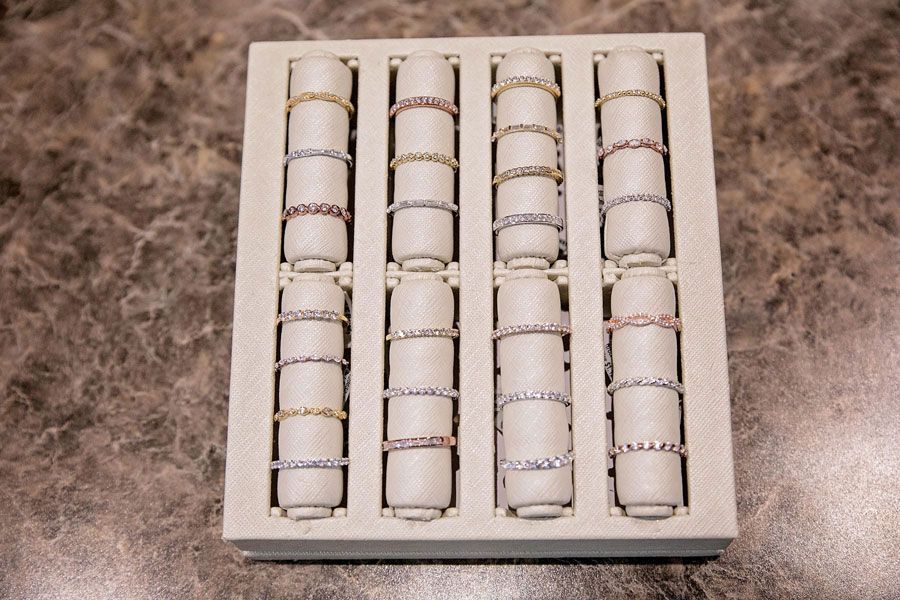 Open box of white cylindrical pieces arranged in four rows on a marbled surface