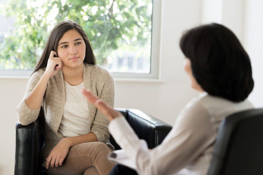 Teenage girl talking to therapist