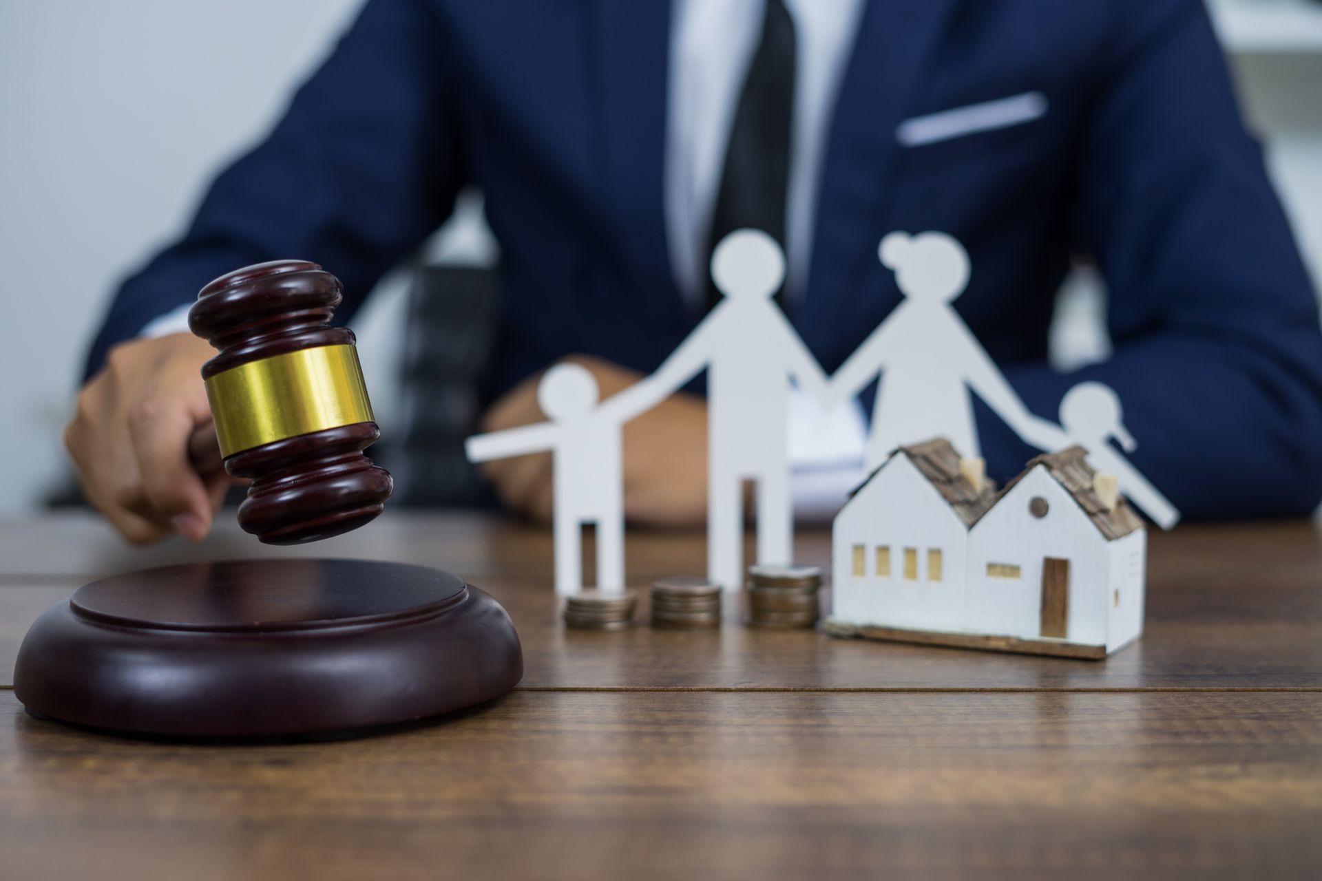 Family figure and gavel symbolizing legal support from a trusted family law attorney. Family figure and gavel symbolizing legal support from a trusted family law attorney.