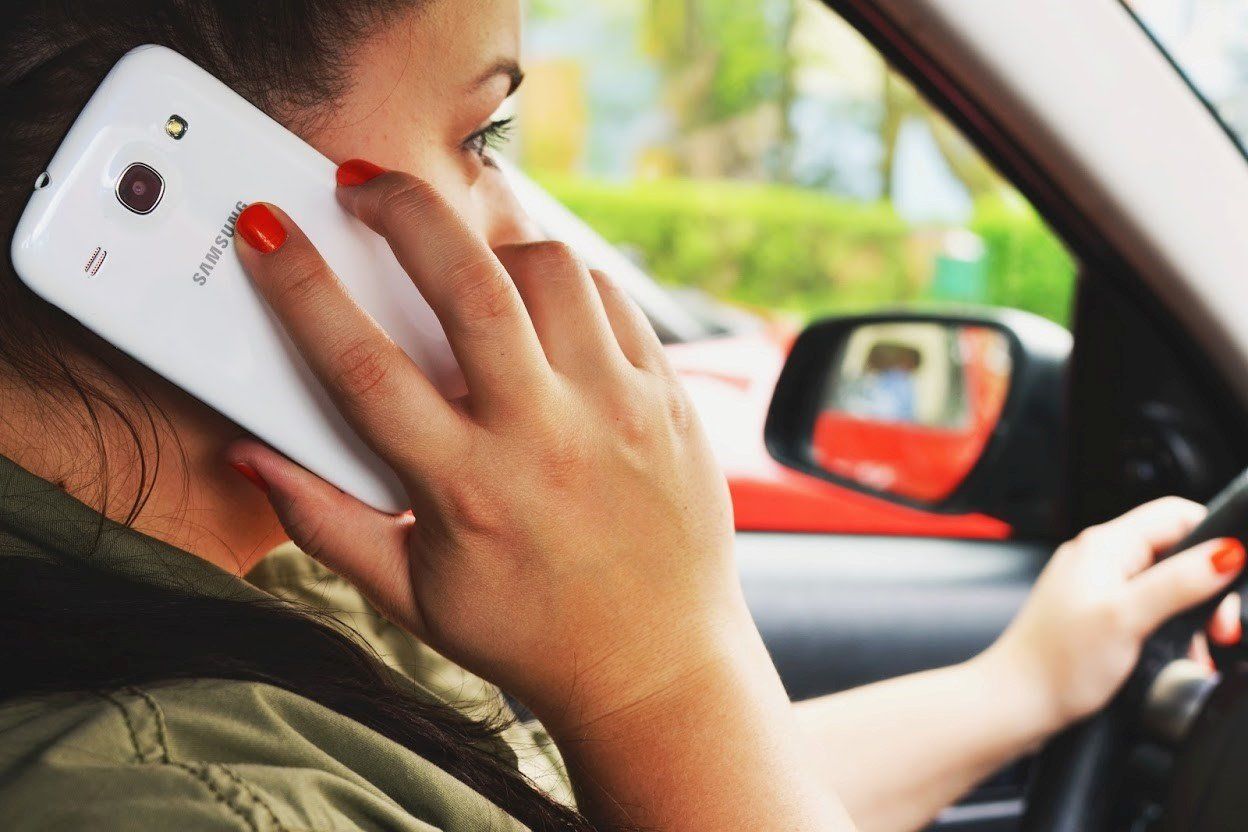 A Young Woman Drives A Car — Idaho Falls, ID — Hart Law Offices, P.C. A Young Woman Drives A Car — Idaho Falls, ID — Hart Law Offices, P.C.