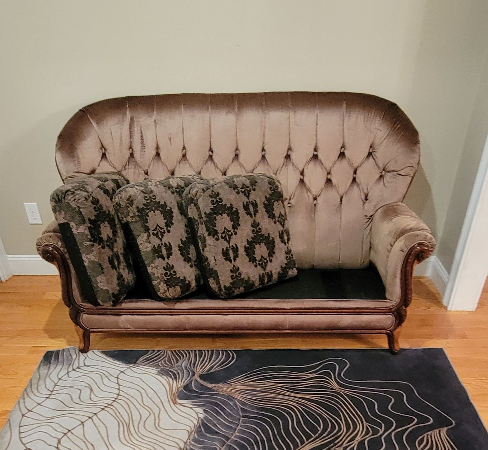 A brown couch with leopard print pillows on it