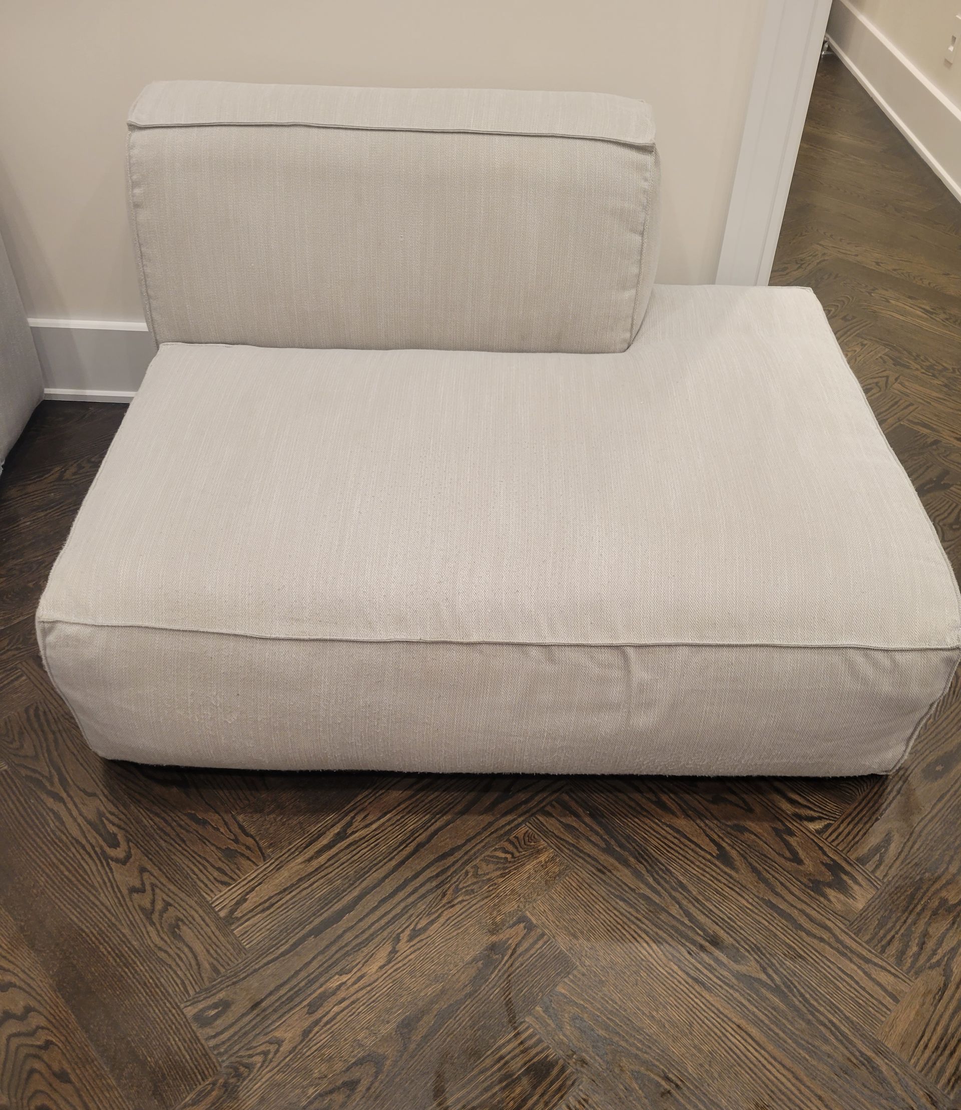 A white chair is sitting on a wooden floor.