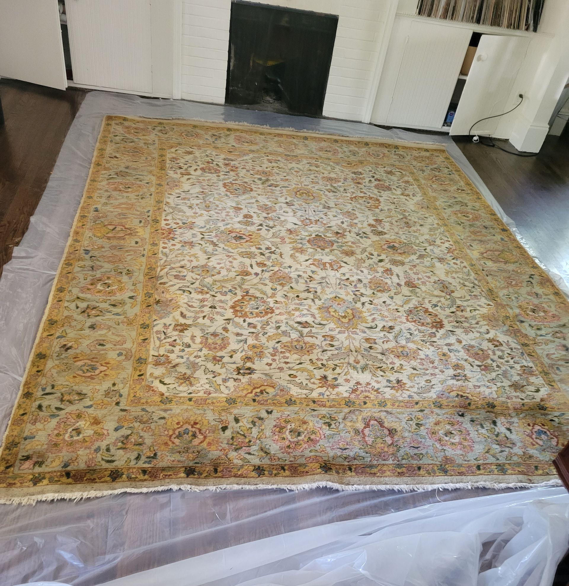 A large rug is sitting on top of a table in a living room.