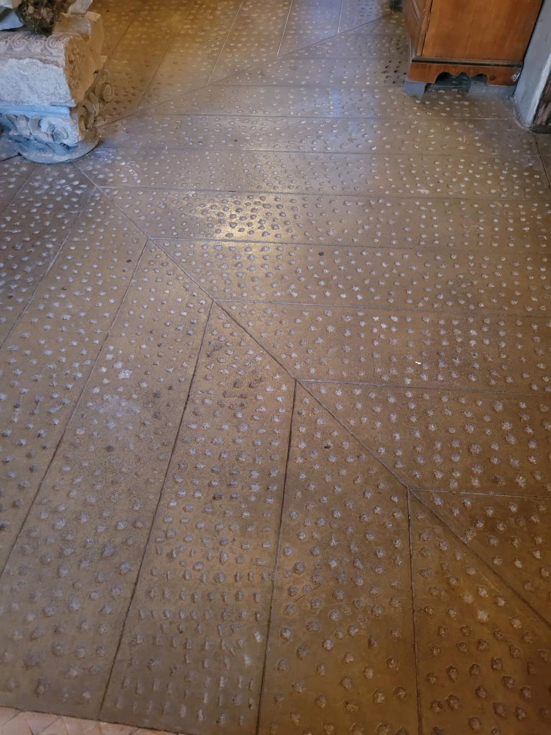 A close up of a tiled floor with white dots on it.