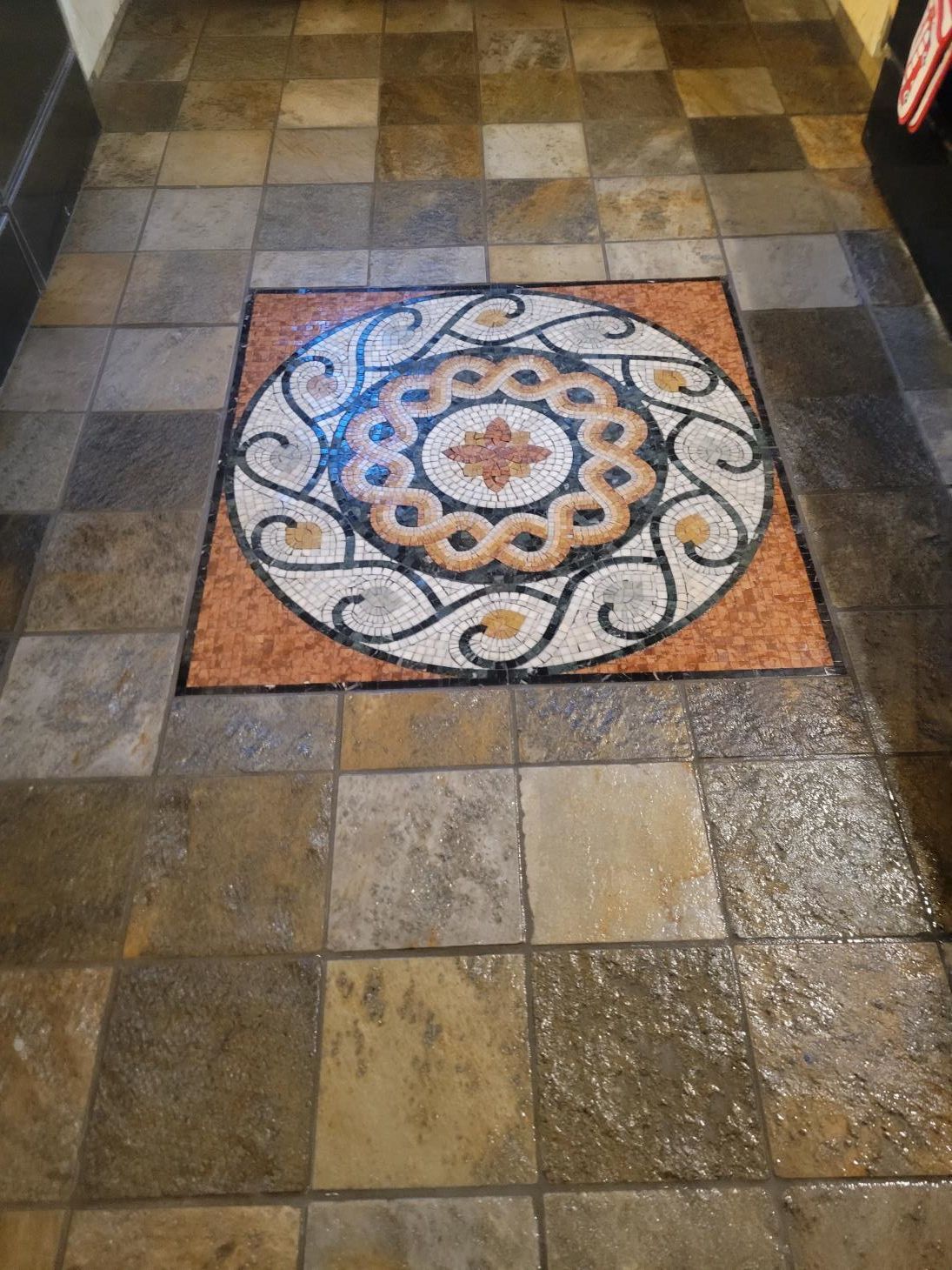 A tiled floor with a circular design on it
