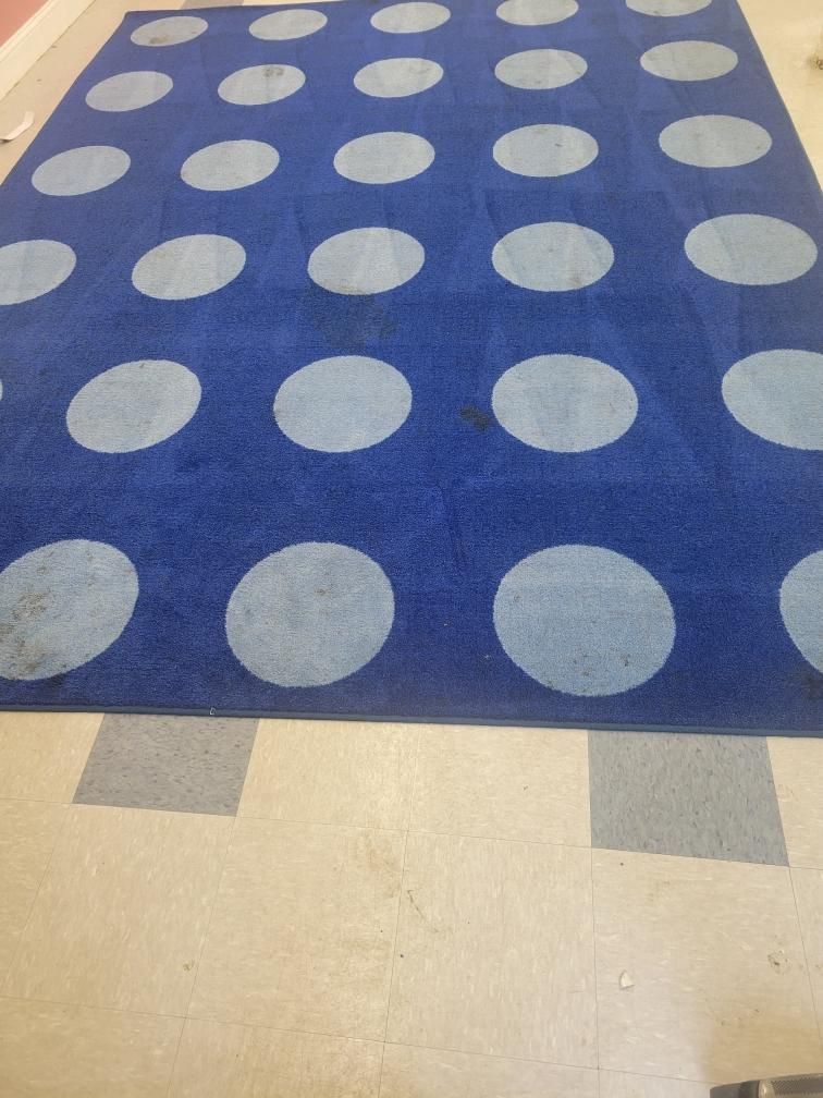 A blue rug with white polka dots on it