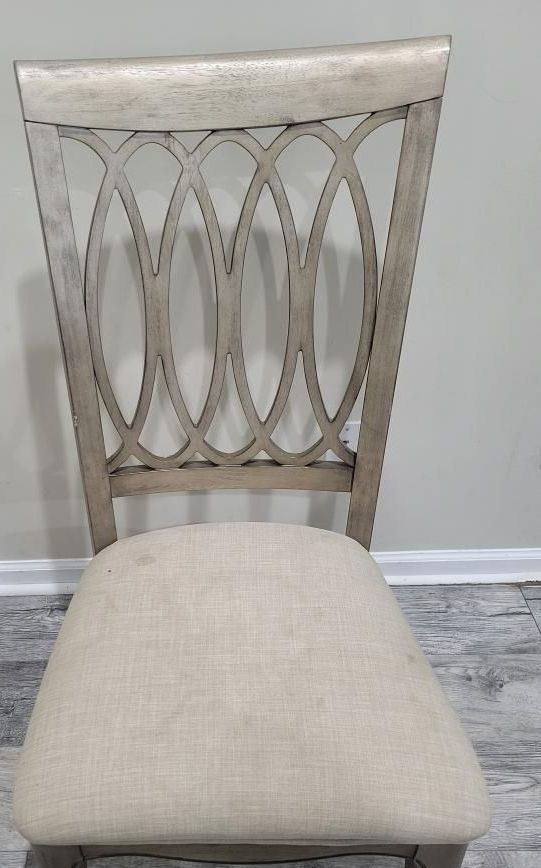 A chair is sitting on a wooden floor next to a wall.