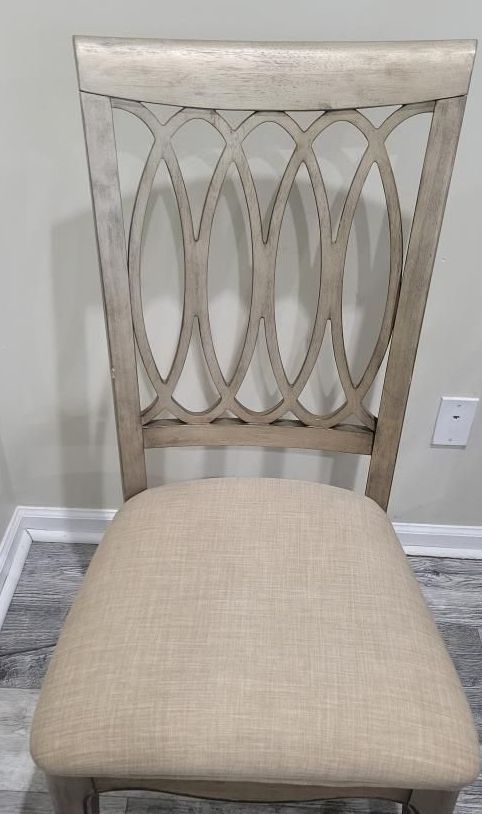 A chair is sitting on a wooden floor in a room.