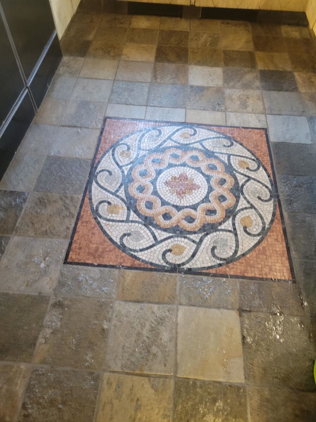 A tiled floor with a circular design on it