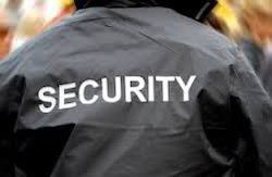 Back of a black security jacket with large white “SECURITY” text