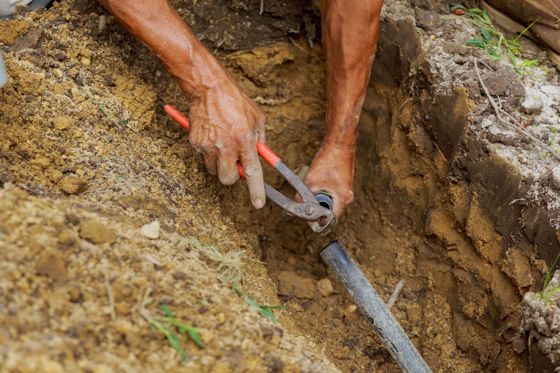 Irrigation expert repairing a sprinkler system in Florida