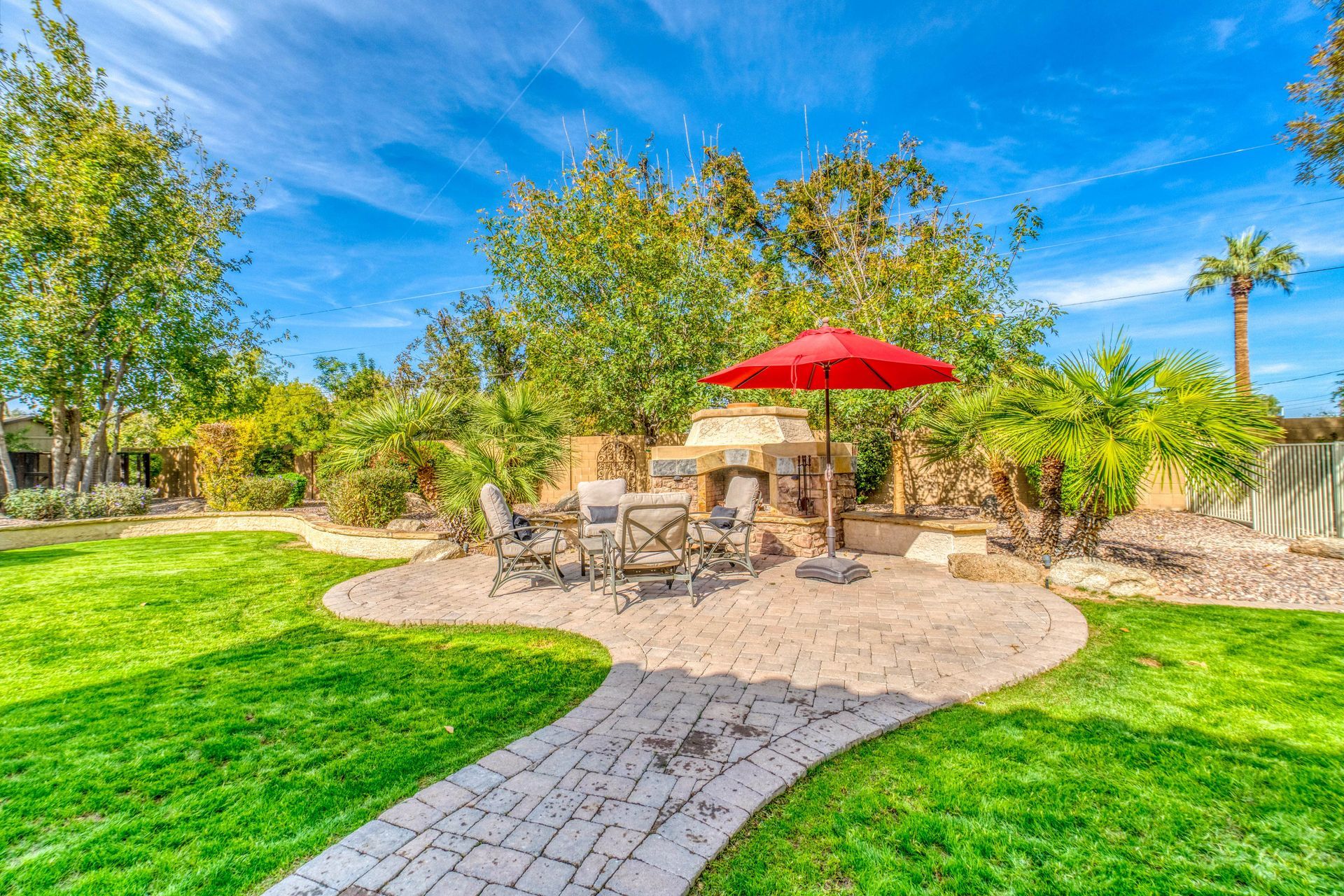 lawn chairs and umberalla on stone path in Florida backyard on a sunny day