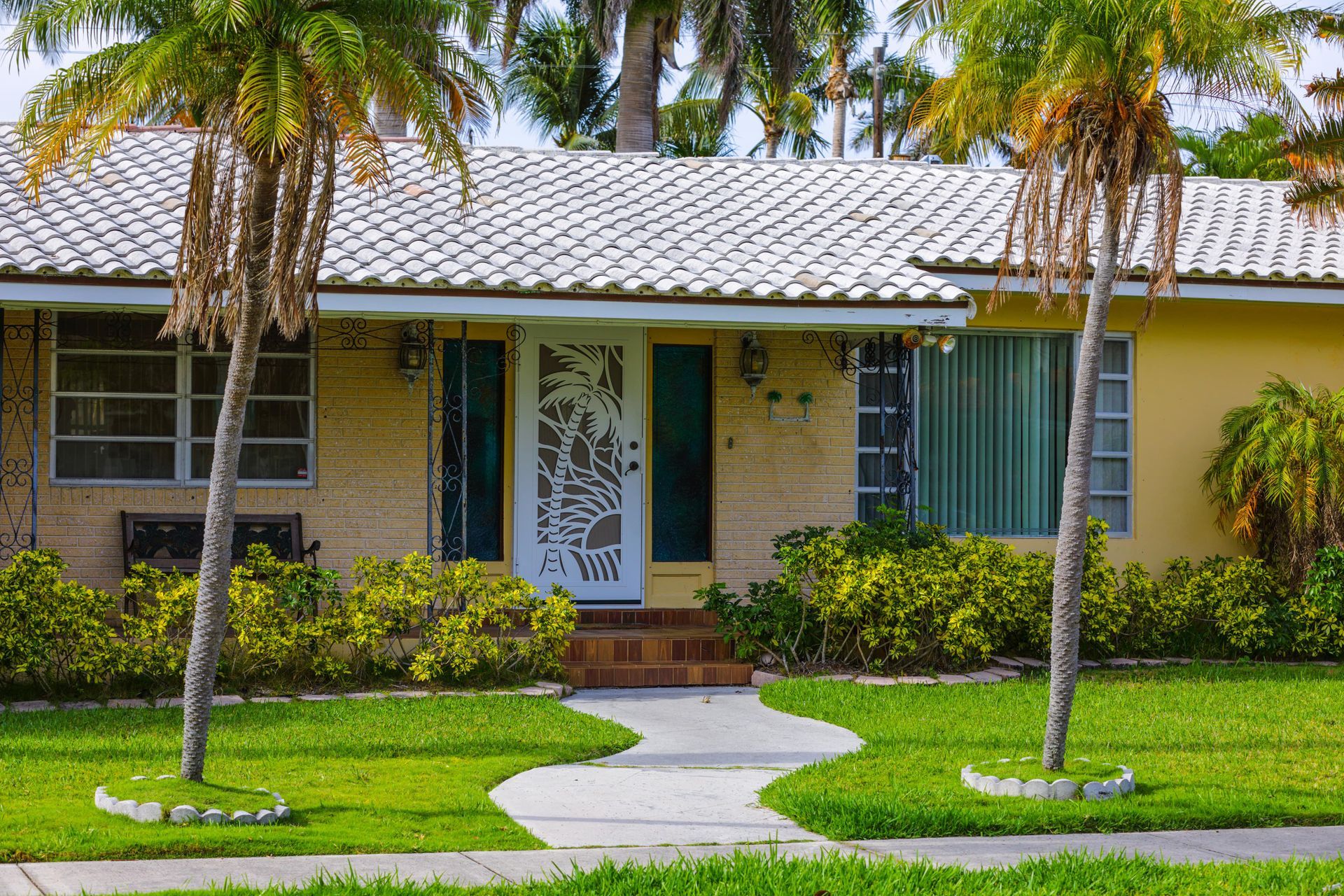 House in Lehigh Acres Florida with palm trees in front yard