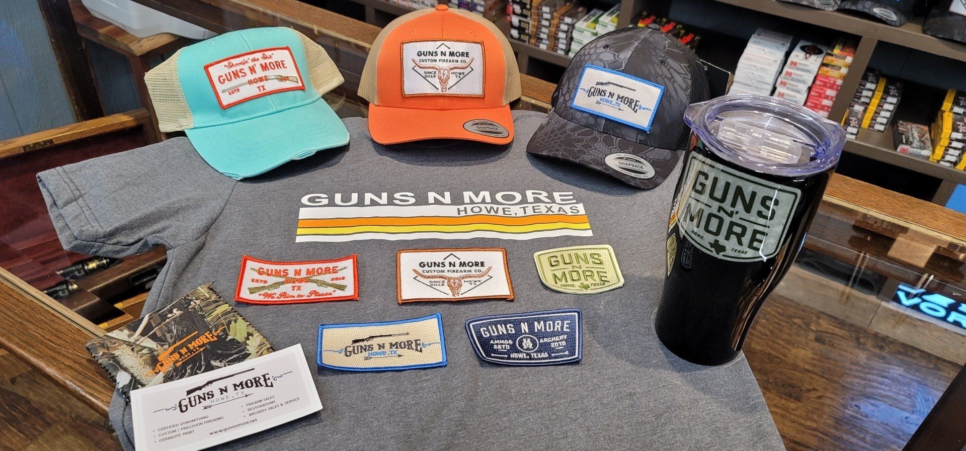 A table topped with a variety of hats and a cup that says `` sun 's more ''.
