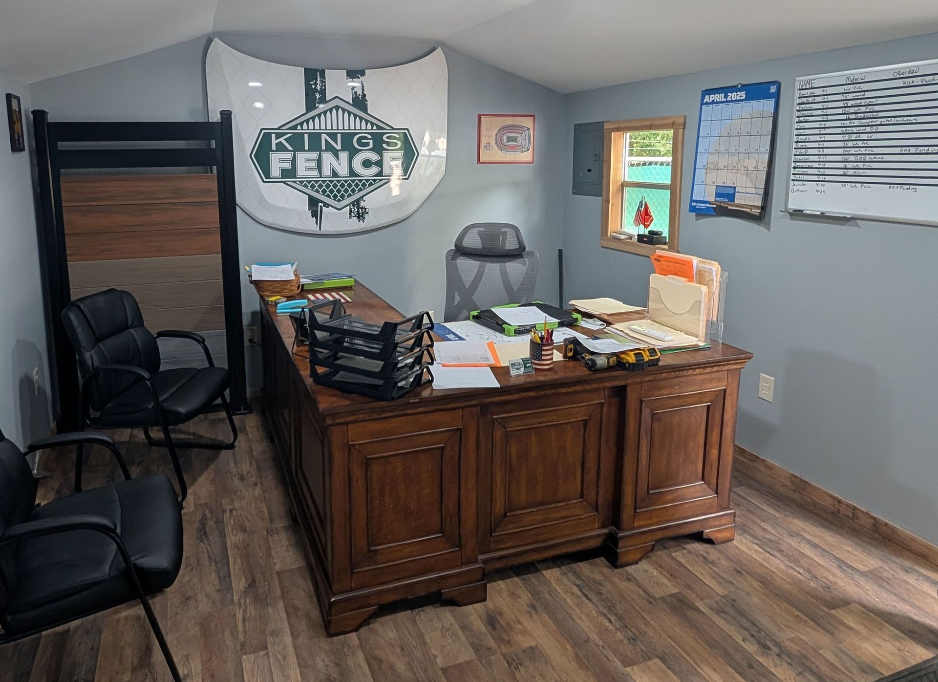 There is a sign on the wall above the desk that says kingsville fence.