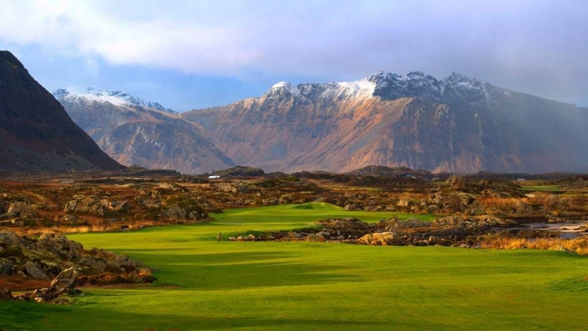 Snow-capped mountains view of fairway at lofoton golf links