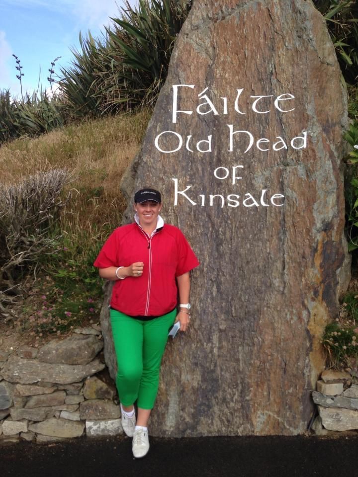 golfer standing at rock entrance of Old Head golf Club Ireland