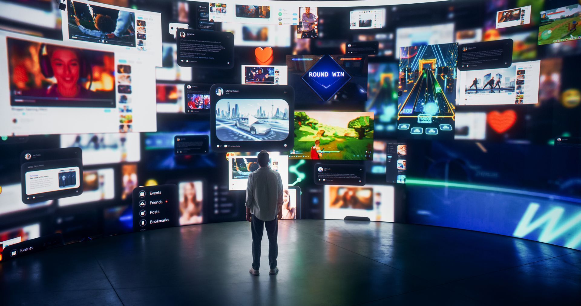 A Man is Standing in Front of a Wall of Computer Monitors