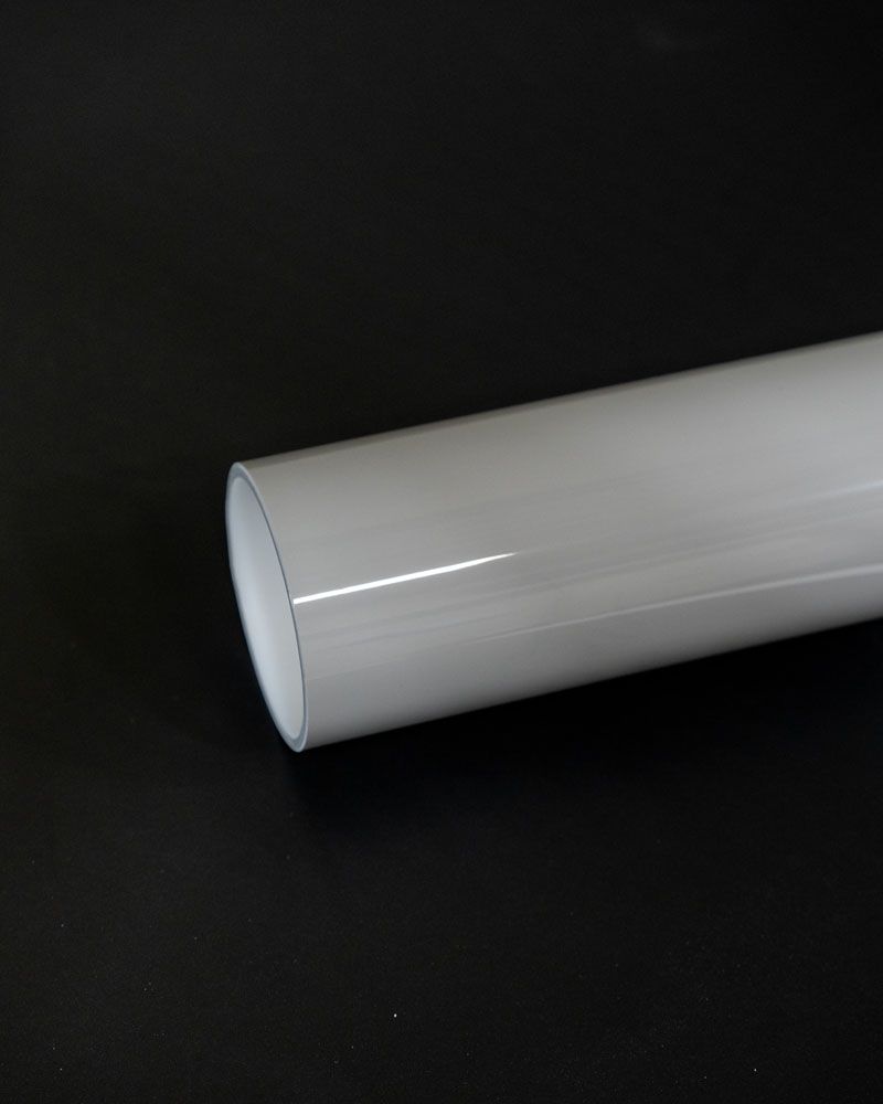 A white tube is sitting on a black surface.