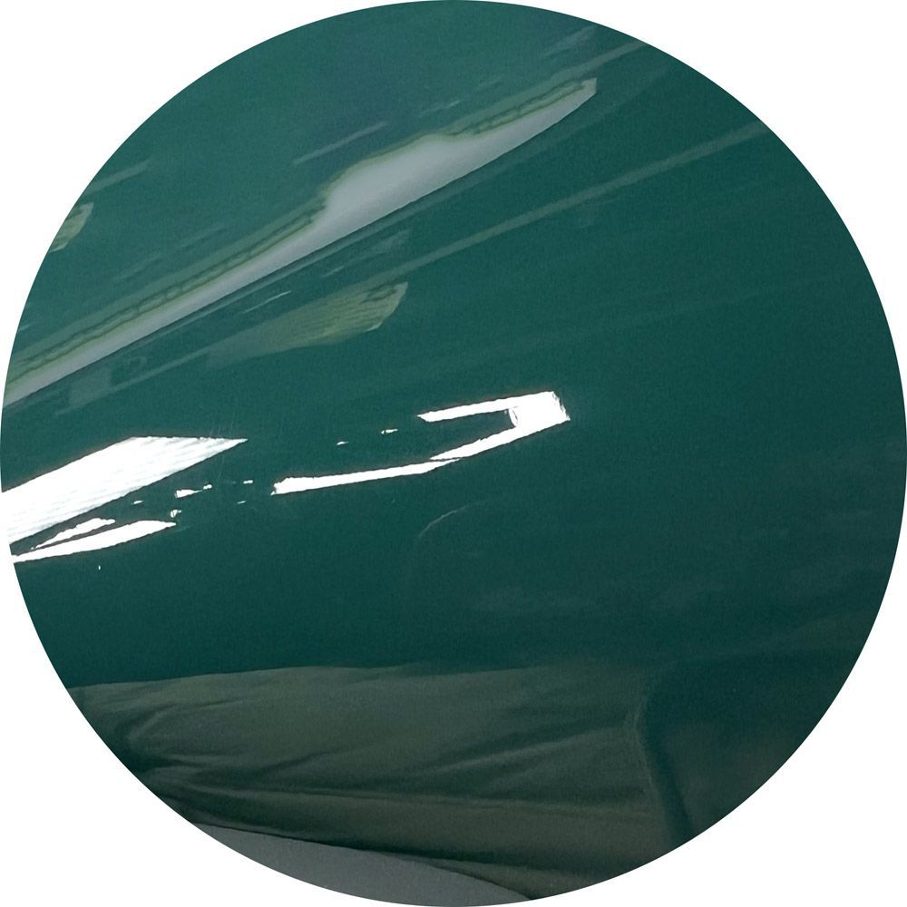 A close up of a green car in a circle
