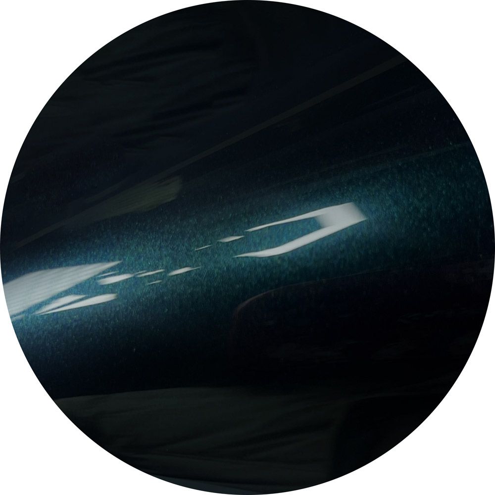 A black circle with a white arrow pointing to the right