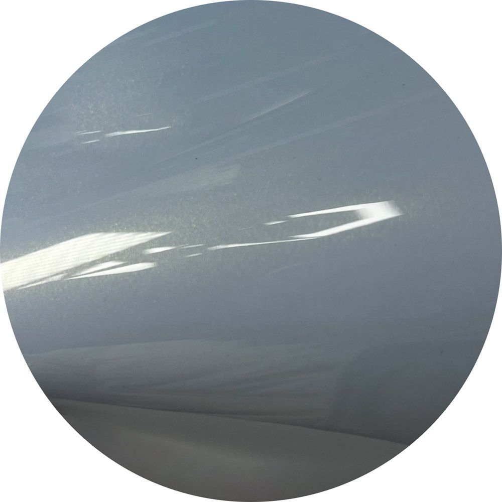 A close up of a gray circle with a white background
