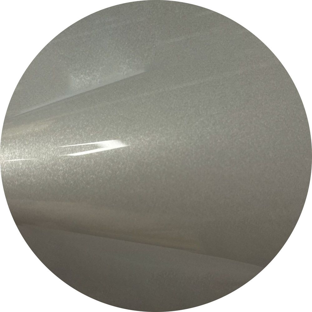 A close up of a silver circle with a white background