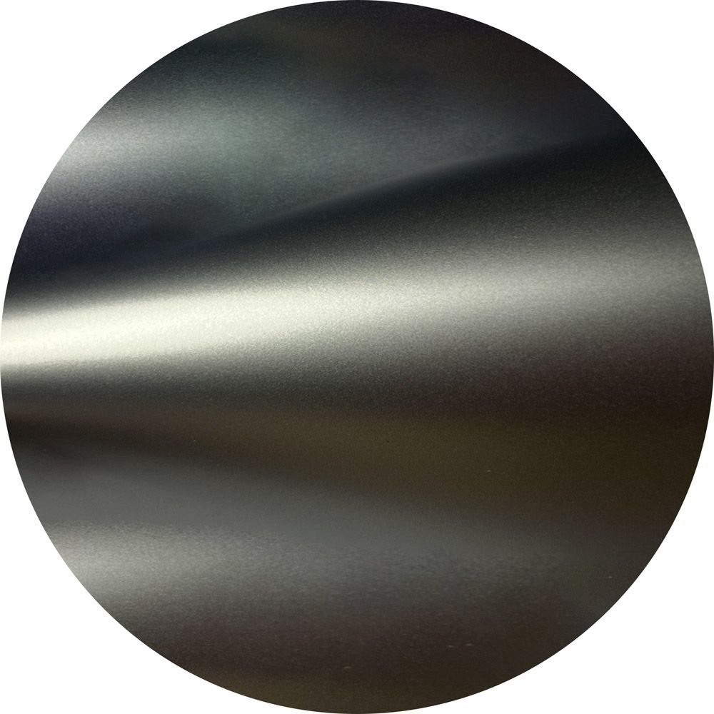 A close up of a metal circle with a white background