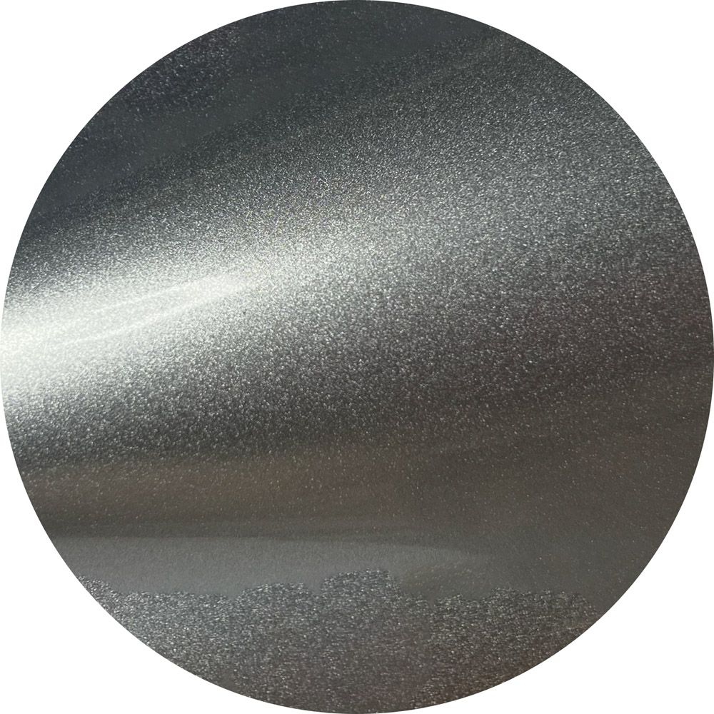 A close up of a silver circle on a white background