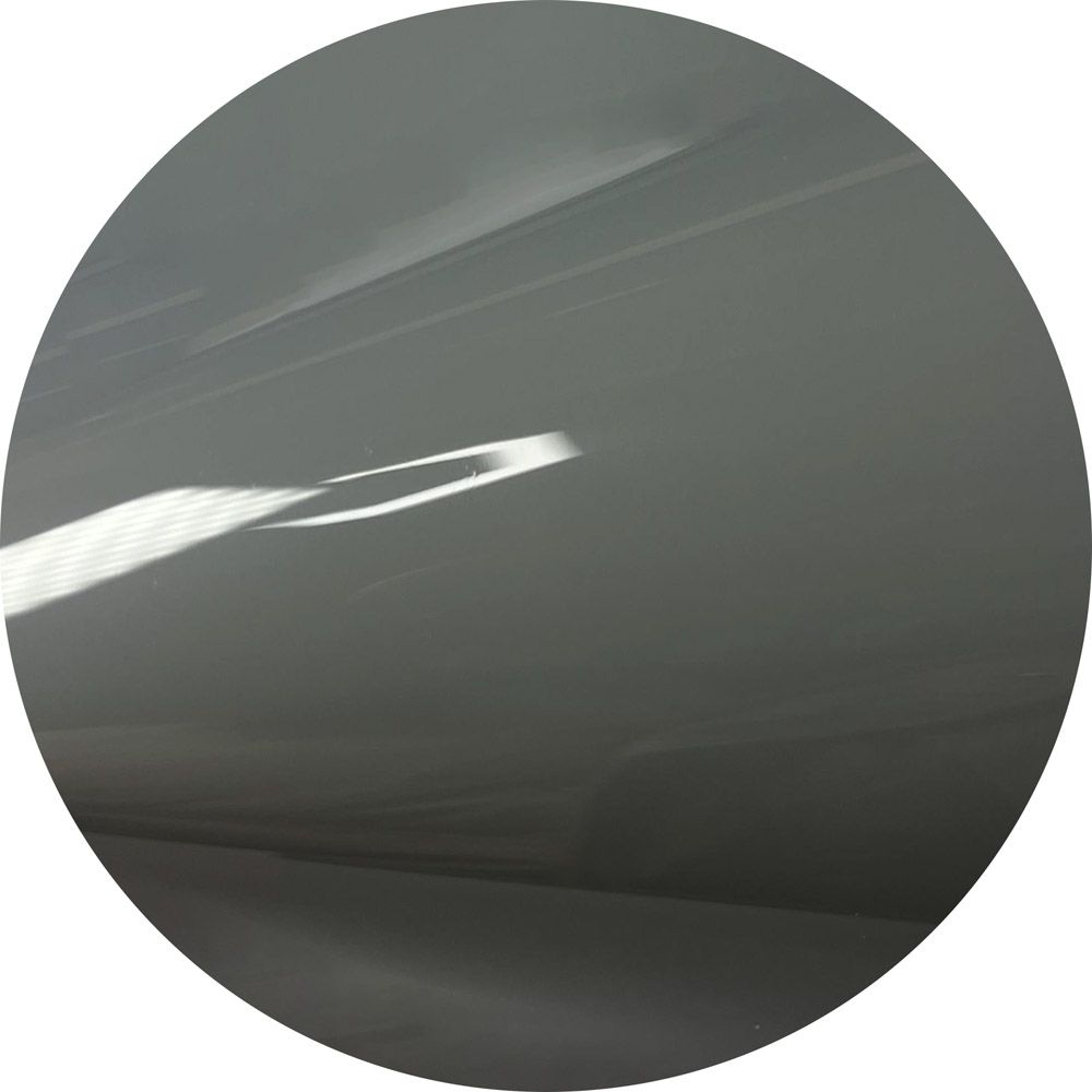 A close up of a gray circle with a light shining through it