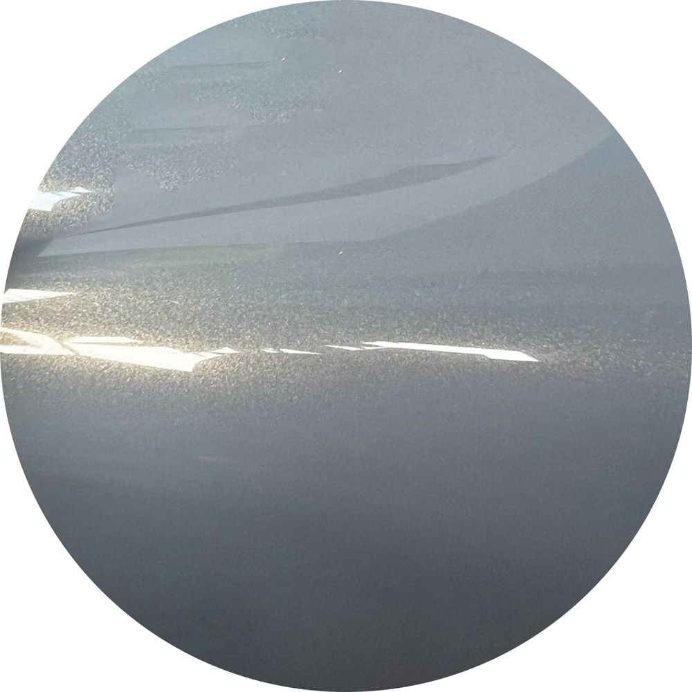 A close up of a gray circle with a white background