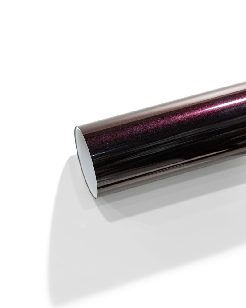 A roll of purple vinyl wrap is sitting on a white surface.