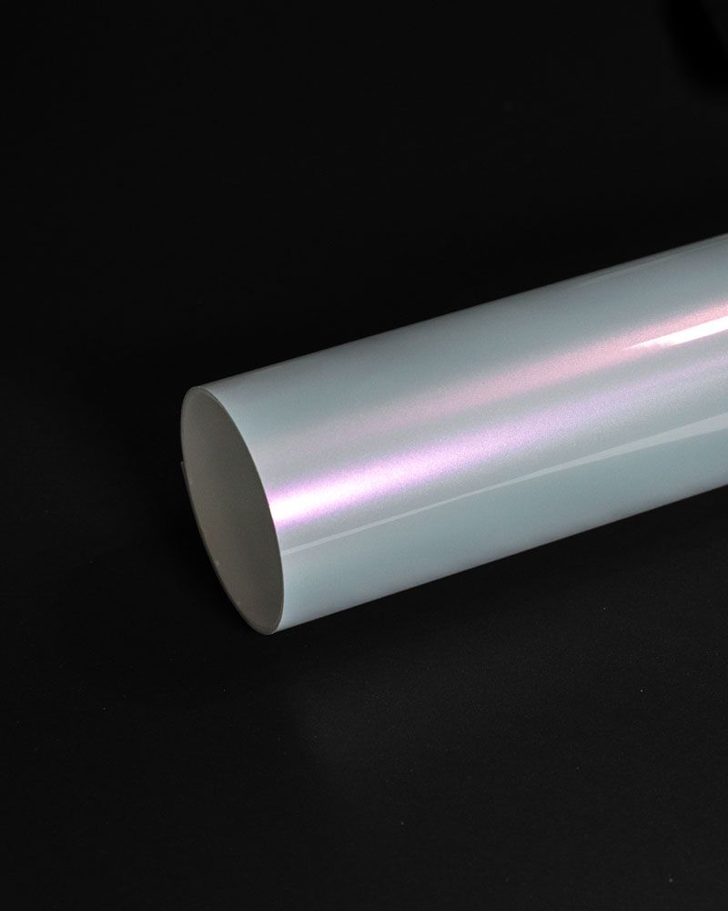 A close up of a white pipe on a black background.