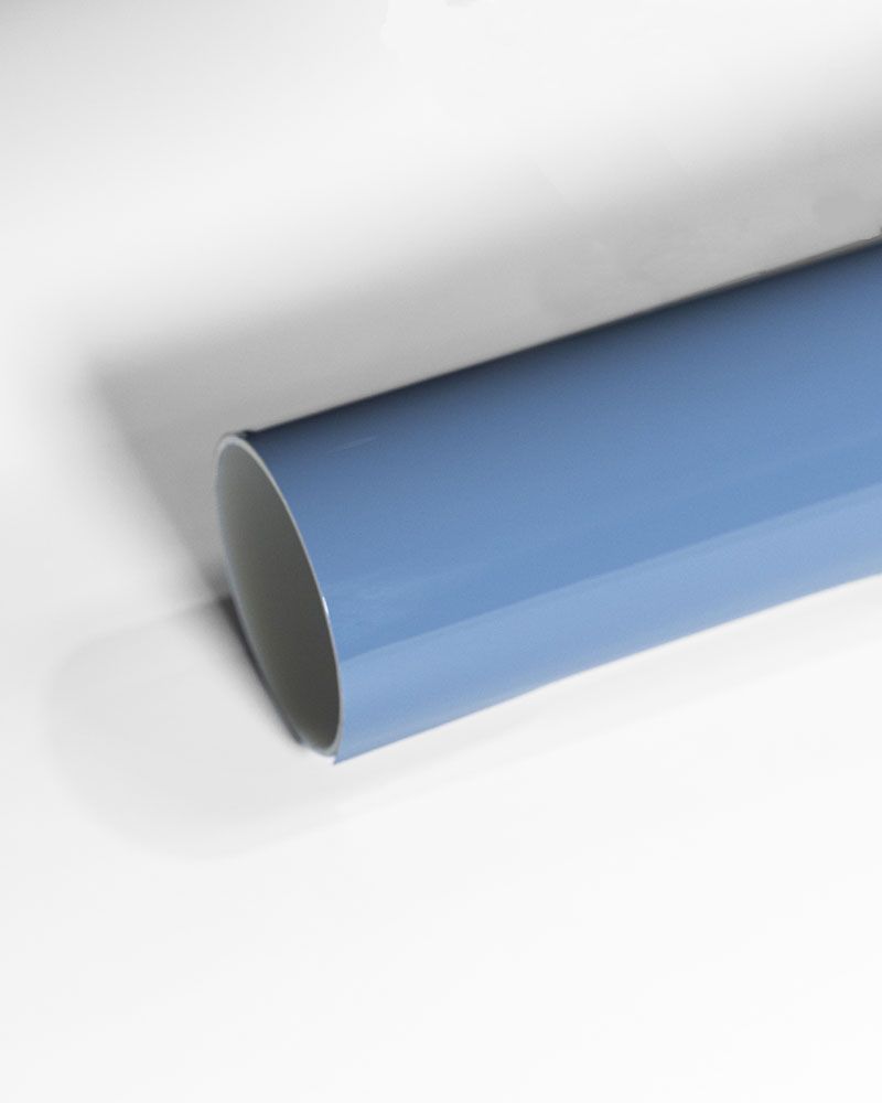 A close up of a blue pipe on a white surface.