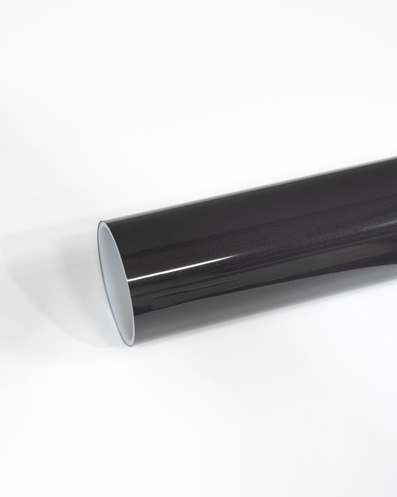 A close up of a black tube on a white surface.