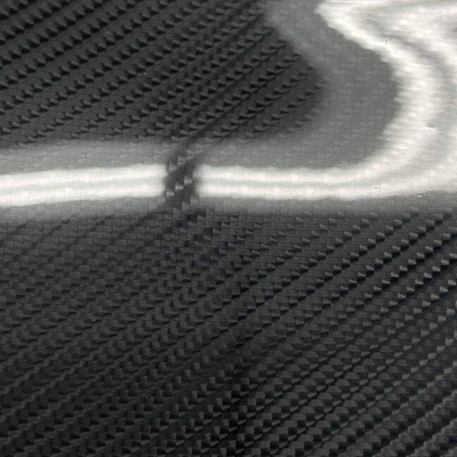A black and white photo of a piece of carbon fiber.