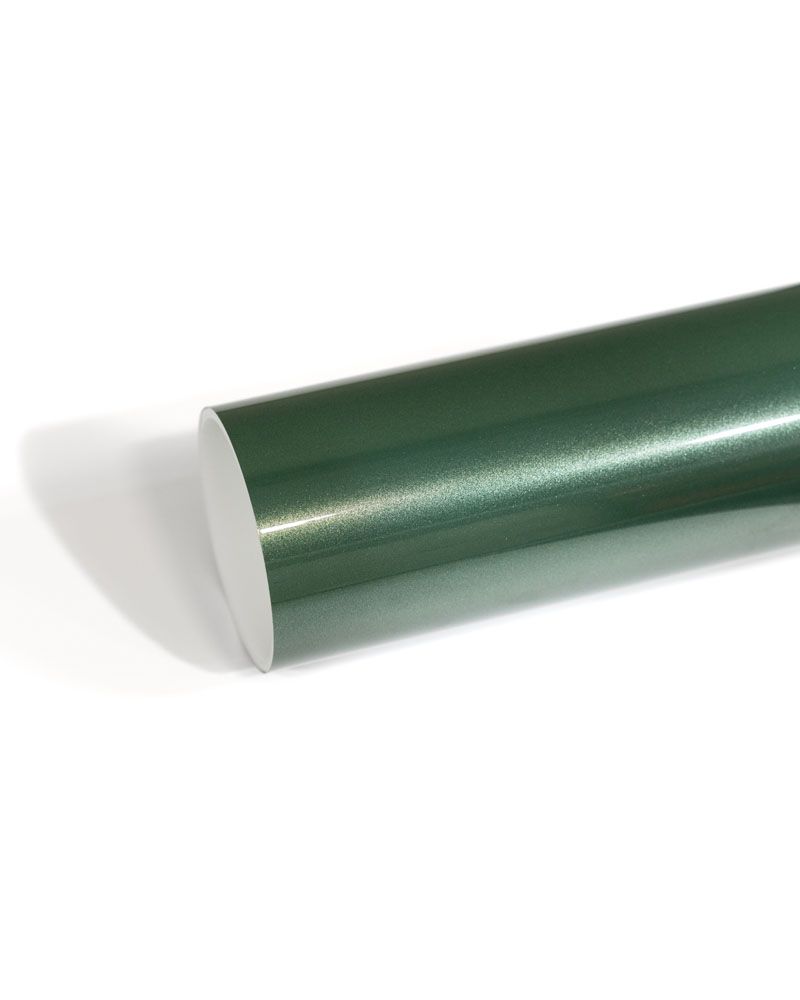 A roll of green vinyl wrap is sitting on a white surface.