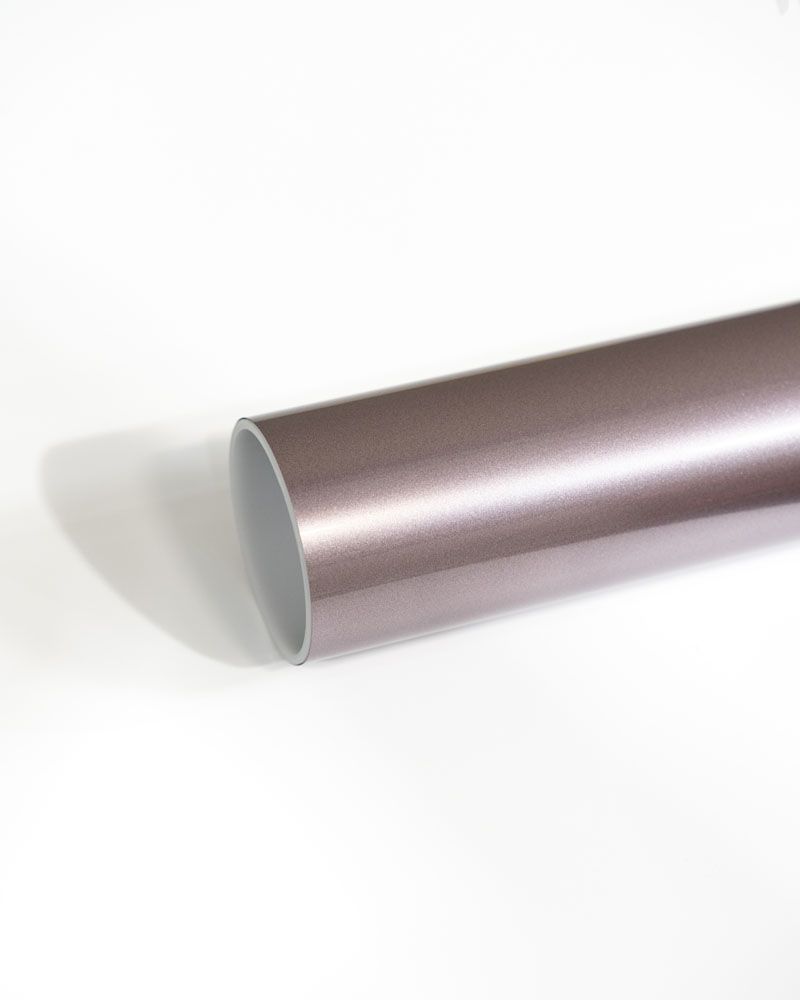 A close up of a metal pipe on a white surface.