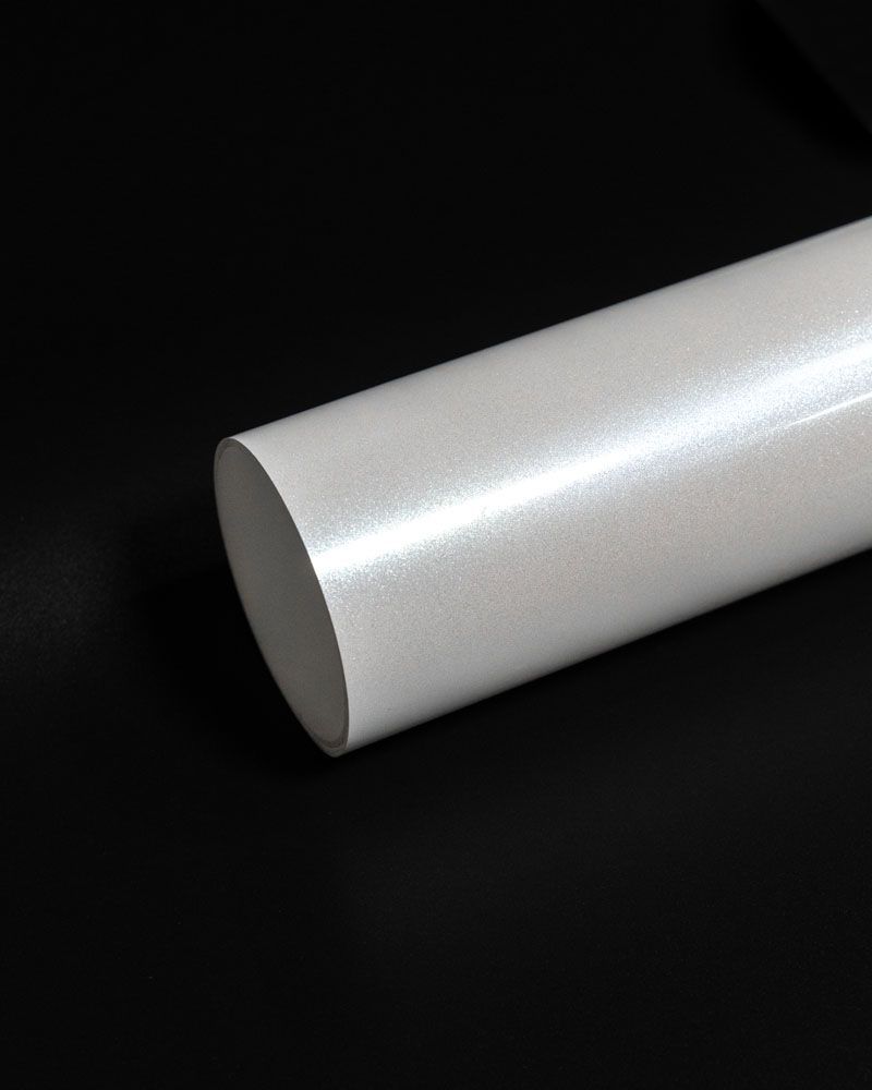 A white tube is sitting on a black surface.