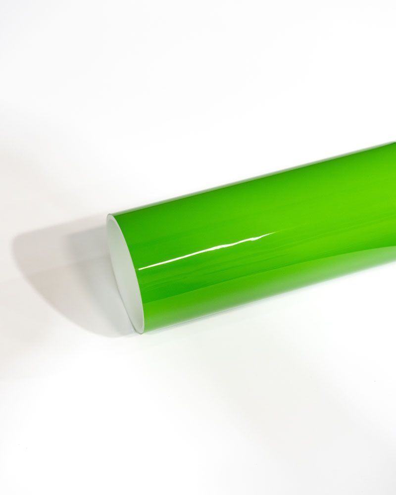 A roll of green vinyl wrap is sitting on a white surface.
