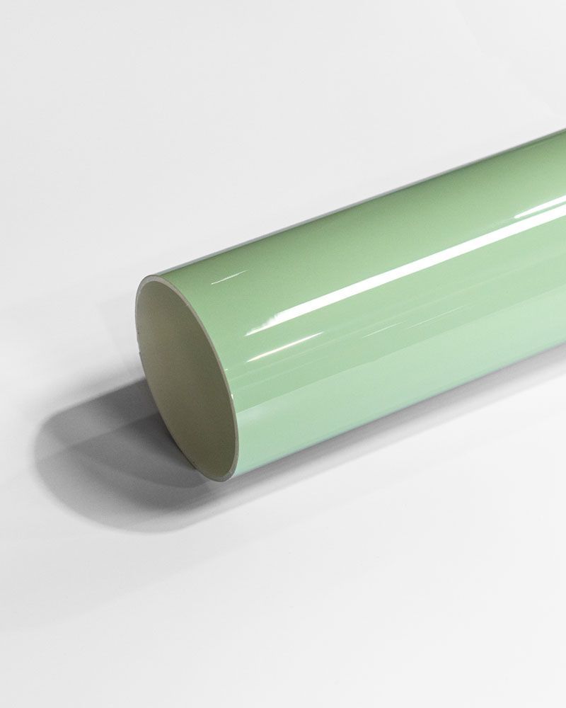 A roll of green vinyl wrap is sitting on a white surface.