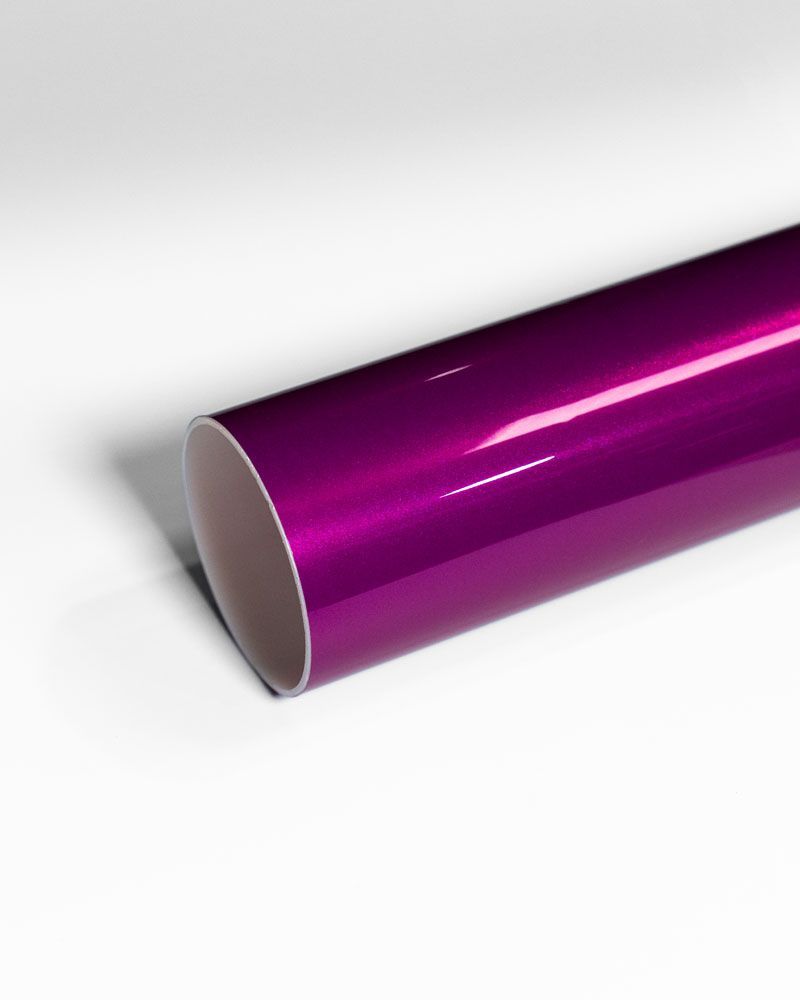 A close up of a purple tube on a white surface.