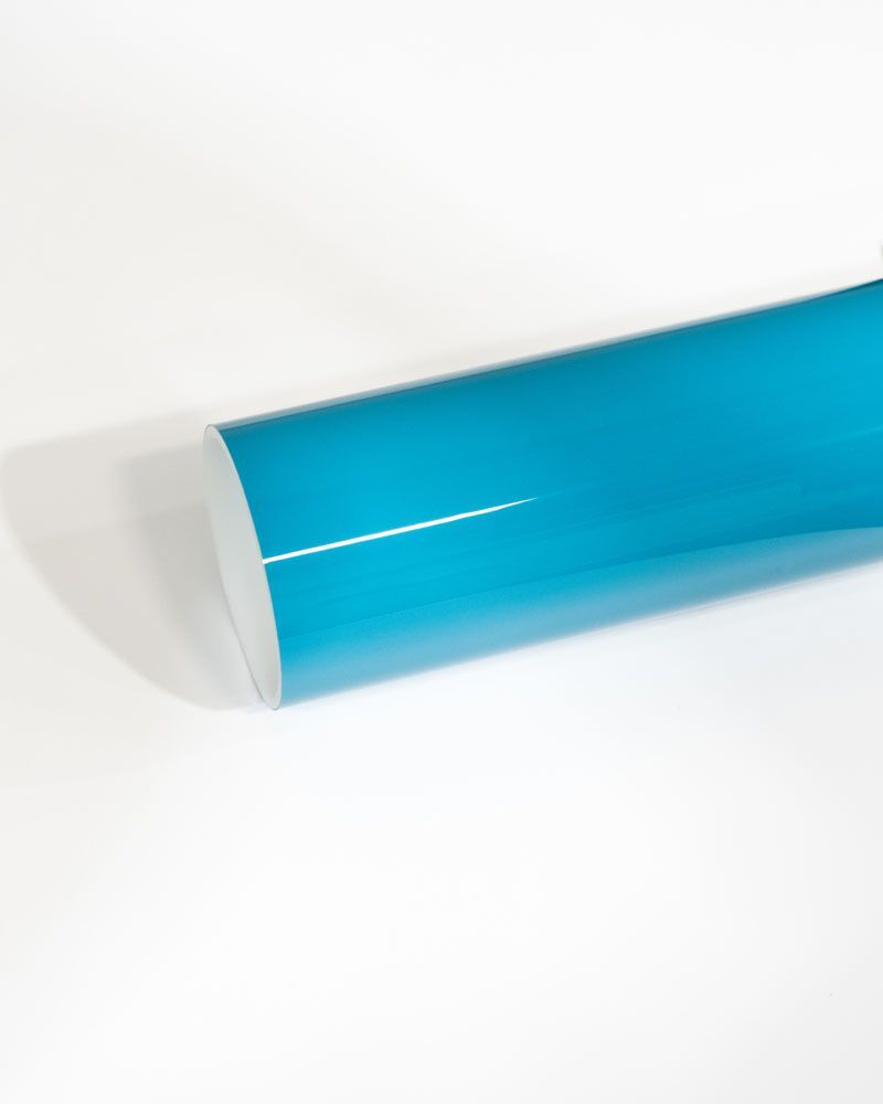 A close up of a blue tube on a white surface.