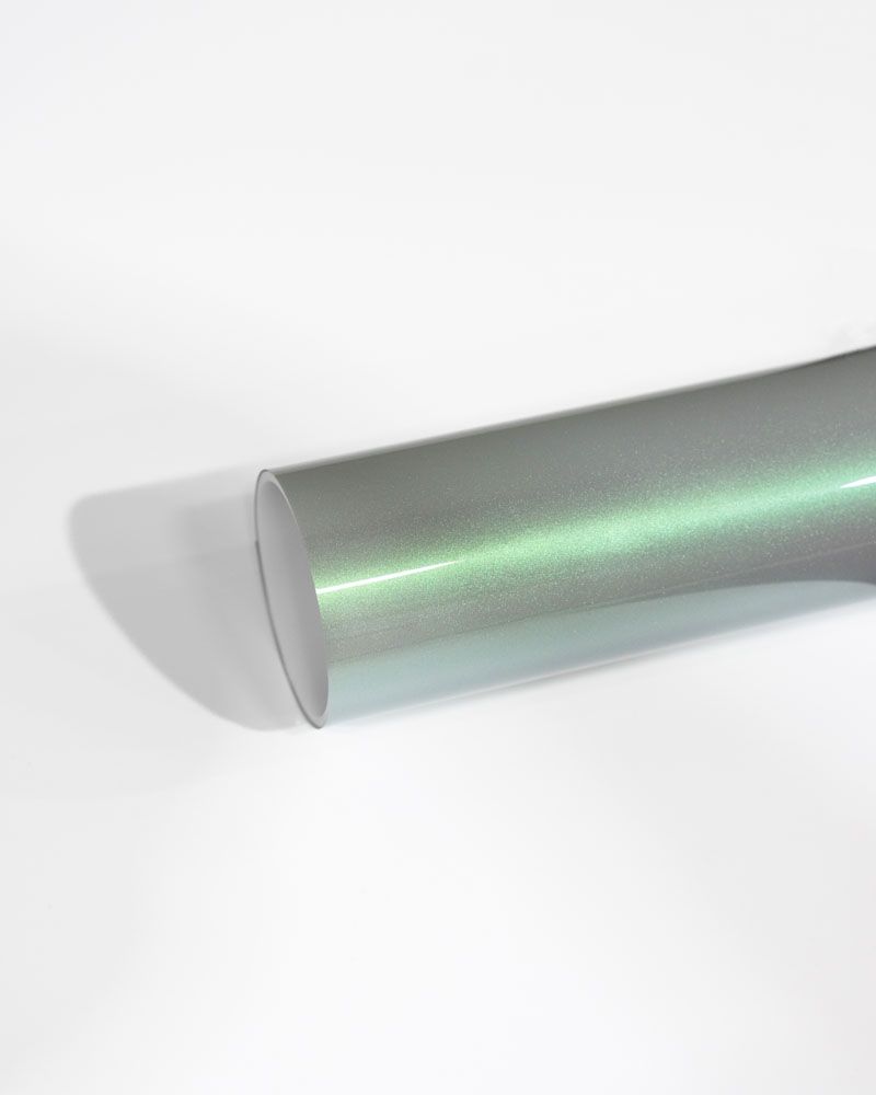 A close up of a metal rod on a white surface.